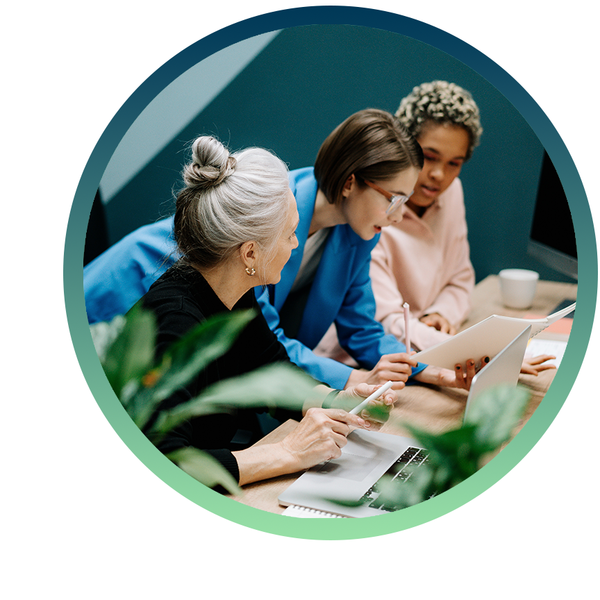 A team discusses project ideas while sharing a laptop and paperwork. A team discusses project ideas while sharing a laptop and paperwork.